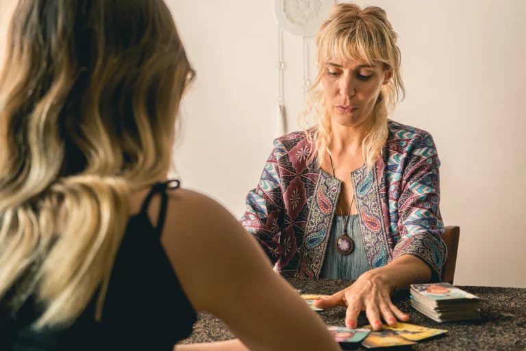 A psychic performing a tarot card reading session with a client.